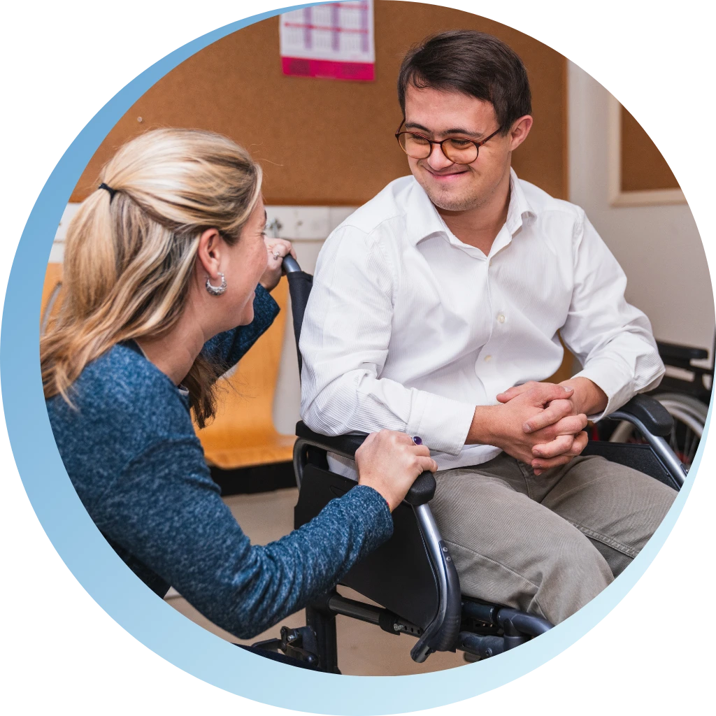 women helping men on disabled men on wheelchair