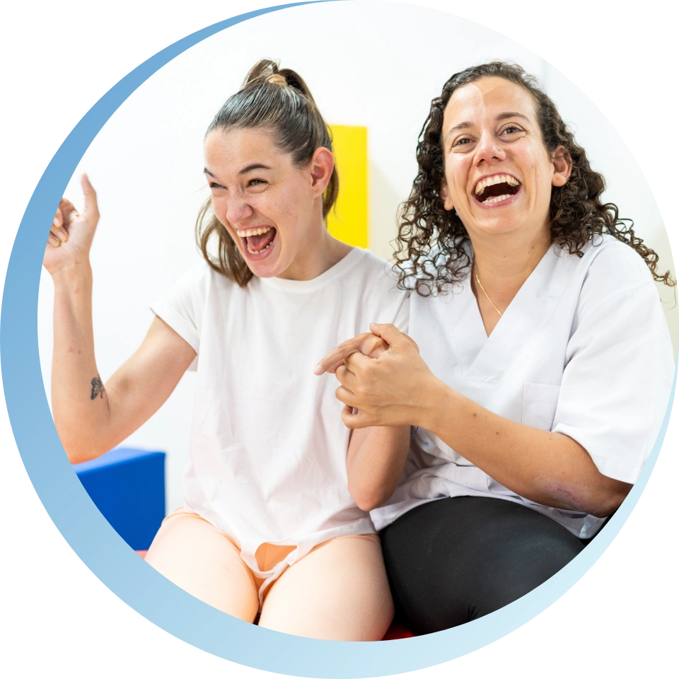 women holding hands with a down syndrome girl and laughing together